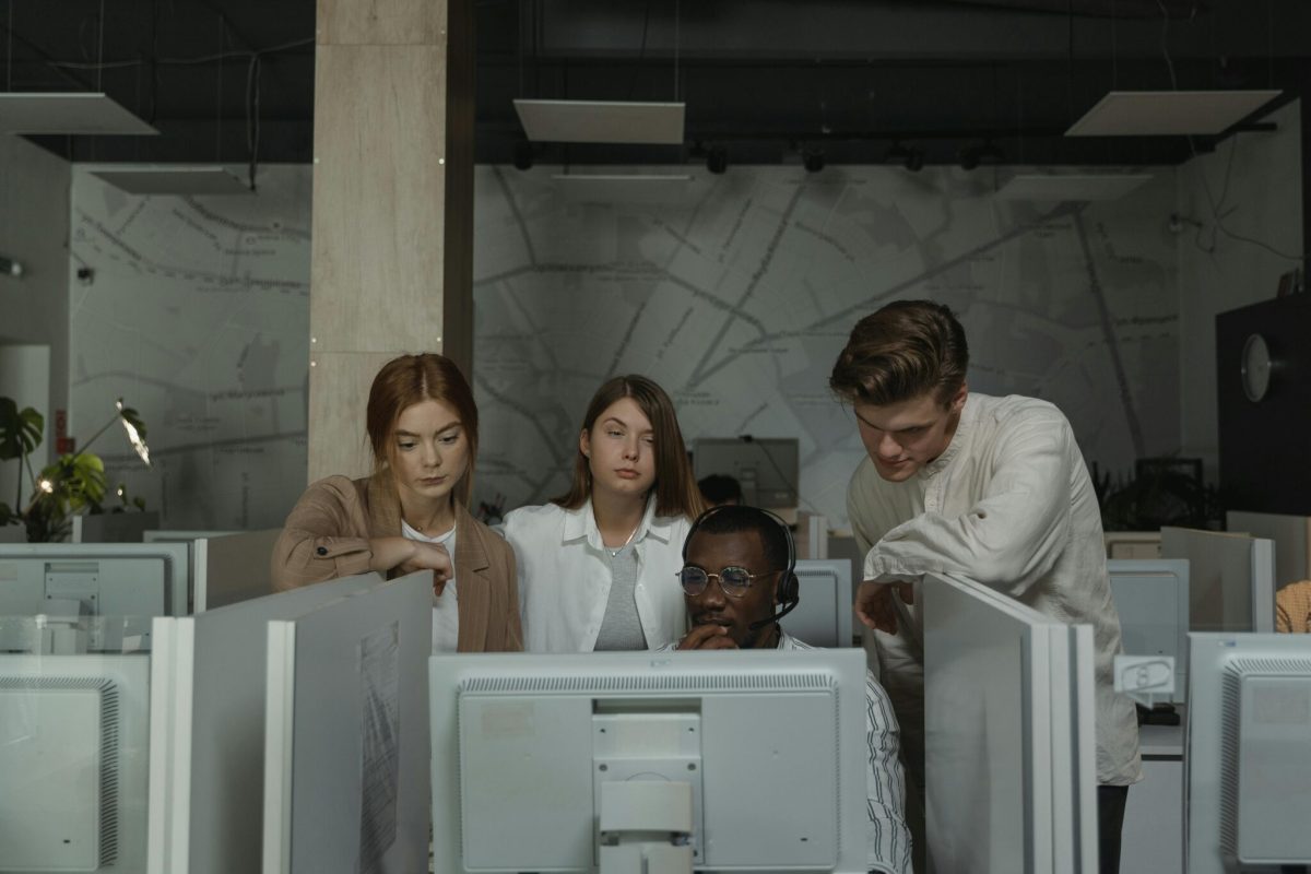 A group of colleagues looking at a computer