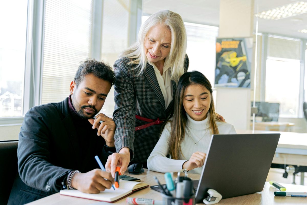 A team working on their laptop in an office